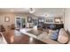 Open-plan living room featuring modern furnishings, wood-style floors and access to the outdoor living space at 210 Lakeview Dr, Anna Maria, FL 34216