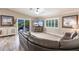 Cozy living room featuring a large sectional sofa, a modern TV, and bright windows with shutters at 210 Lakeview Dr, Anna Maria, FL 34216