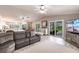 Bright living room features vaulted ceiling, tile floors, and sliding glass doors leading to outdoor deck at 210 Lakeview Dr, Anna Maria, FL 34216