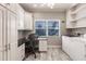 Bright office/laundry area featuring built-in cabinets, desk, and a window view at 210 Lakeview Dr, Anna Maria, FL 34216