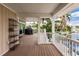 Expansive covered patio with outdoor furniture and water views, perfect for entertaining or relaxing by the canal at 210 Lakeview Dr, Anna Maria, FL 34216