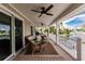 Covered patio featuring wicker seating and views of the canal, offering a relaxing outdoor living space at 210 Lakeview Dr, Anna Maria, FL 34216