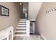 Interior view of gray and white staircase leading to an upper level in a neutral-toned home at 210 Lakeview Dr, Anna Maria, FL 34216