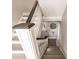 Stairway with white railings and grey steps leading to front door at 210 Lakeview Dr, Anna Maria, FL 34216