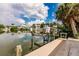 Waterfront featuring a boat lift, providing easy access to the water and stunning views of the neighborhood and sky at 210 Lakeview Dr, Anna Maria, FL 34216