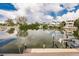 Scenic waterfront view showcasing a boat lift and calm waters reflecting the surrounding neighborhood and sky at 210 Lakeview Dr, Anna Maria, FL 34216