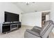 Living room features a large TV, fireplace, and comfortable armchair at 8816 Ascot Ct, Tampa, FL 33634
