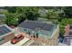 Aerial view of a house with solar panels and a stone driveway at 8816 Ascot Ct, Tampa, FL 33634