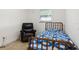 Small bedroom with a twin bed and recliner chair at 8816 Ascot Ct, Tampa, FL 33634