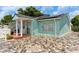 Charming light teal home with a stone driveway at 8816 Ascot Ct, Tampa, FL 33634