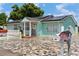 Light teal home with solar panels and stone driveway at 8816 Ascot Ct, Tampa, FL 33634