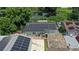 Aerial view of a house with solar panels and a stone driveway at 8816 Ascot Ct, Tampa, FL 33634