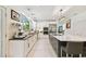 Modern kitchen with large island, white cabinets, and stainless steel appliances at 5709 E Longboat Blvd, Tampa, FL 33615