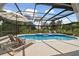 Relaxing screened pool area with lounge chairs at 5709 E Longboat Blvd, Tampa, FL 33615