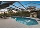 Irregular shaped pool with a covered patio area at 5709 E Longboat Blvd, Tampa, FL 33615