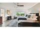 Main bedroom with king bed, wood floors and large window at 5709 E Longboat Blvd, Tampa, FL 33615