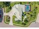 Two-story house with a green roof, a pool, and a beautifully landscaped backyard at 5709 E Longboat Blvd, Tampa, FL 33615