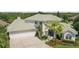 Large house with a green roof, three-car garage, and beautiful landscaping at 5709 E Longboat Blvd, Tampa, FL 33615