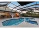 Relaxing pool and spa area with covered patio, great for outdoor living at 5709 E Longboat Blvd, Tampa, FL 33615