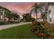 Landscaped front yard showcasing curb appeal and waterfront views at 5709 E Longboat Blvd, Tampa, FL 33615