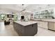 Modern kitchen with large island, white cabinets, and stainless steel appliances at 5709 E Longboat Blvd, Tampa, FL 33615