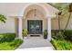 Elegant entryway with arched doorway and columns at 5709 E Longboat Blvd, Tampa, FL 33615