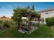 Wooden pergola with seating and grill, ideal for outdoor dining at 5709 E Longboat Blvd, Tampa, FL 33615