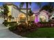 Elegant entryway with double doors and lush landscaping at 5709 E Longboat Blvd, Tampa, FL 33615