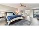 Main bedroom with king bed, sitting area and access to a balcony at 5709 E Longboat Blvd, Tampa, FL 33615