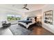 Main bedroom with king bed, window and modern decor at 5709 E Longboat Blvd, Tampa, FL 33615