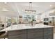 Modern kitchen with large island, white cabinets, and stainless steel appliances at 5709 E Longboat Blvd, Tampa, FL 33615