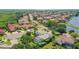 Two-story house with a green roof and a pool, situated in a waterfront community at 5709 E Longboat Blvd, Tampa, FL 33615
