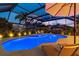 Night view of the pool area with patio and lights at 5709 E Longboat Blvd, Tampa, FL 33615
