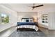 Main bedroom with king bed, ceiling fan and sitting area at 5709 E Longboat Blvd, Tampa, FL 33615