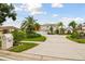 Two-story house with a three-car garage and lush landscaping at 5709 E Longboat Blvd, Tampa, FL 33615