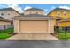 Tan garage door with landscaping and driveway at 11329 Emerson Lake Dr, Riverview, FL 33578