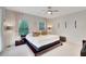 Spacious main bedroom with a large bed and access to balcony at 11329 Emerson Lake Dr, Riverview, FL 33578