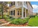 Two story house with light beige siding, dark shutters, and a manicured lawn at 11329 Emerson Lake Dr, Riverview, FL 33578
