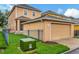 Attached garage with tan exterior and grassy area at 11329 Emerson Lake Dr, Riverview, FL 33578