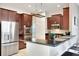 Modern kitchen with stainless steel appliances and dark wood cabinets at 11329 Emerson Lake Dr, Riverview, FL 33578