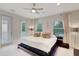 Main bedroom with king-size bed and private balcony access at 11329 Emerson Lake Dr, Riverview, FL 33578