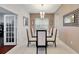 Bright dining area with glass-top table and access to the kitchen at 11329 Emerson Lake Dr, Riverview, FL 33578