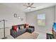 Bright bedroom with a sectional sofa and ceiling fan at 11329 Emerson Lake Dr, Riverview, FL 33578
