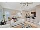 Bright living room with white sofa and adjacent kitchen bar at 11329 Emerson Lake Dr, Riverview, FL 33578