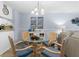 Charming dining area with glass-top table and wicker chairs at 16308 Gulf Blvd # 209, Redington Beach, FL 33708