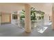 Bright hallway with white railings and tropical plants at 16308 Gulf Blvd # 209, Redington Beach, FL 33708
