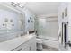 Clean bathroom with a tub, shower, and marble vanity at 16308 Gulf Blvd # 209, Redington Beach, FL 33708