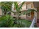 Lush tropical landscaping in a condo courtyard at 16308 Gulf Blvd # 209, Redington Beach, FL 33708