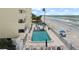 Community pool with ocean views and ample lounge chairs at 16308 Gulf Blvd # 209, Redington Beach, FL 33708