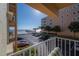 Stunning ocean view from balcony, showcasing beach, pier, and parking lot at 16308 Gulf Blvd # 209, Redington Beach, FL 33708